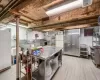 Kitchen featuring white refrigerator, light hardwood / wood-style flooring, and high end stove