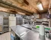 Kitchen featuring stainless steel counters, light hardwood / wood-style floors, and white appliances