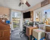 Carpeted office with ceiling fan and a textured ceiling