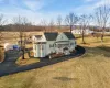 Rear view of house with a lawn and covered porch