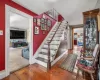 Stairway featuring wood-type flooring and a textured ceiling