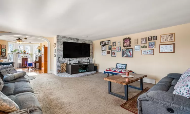 Living room featuring ceiling fan and light colored carpet