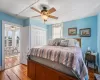 Bedroom featuring hardwood floors, ceiling fan, and a closet