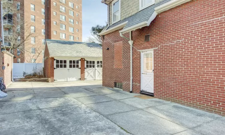 View of side of property featuring an outbuilding and a garage