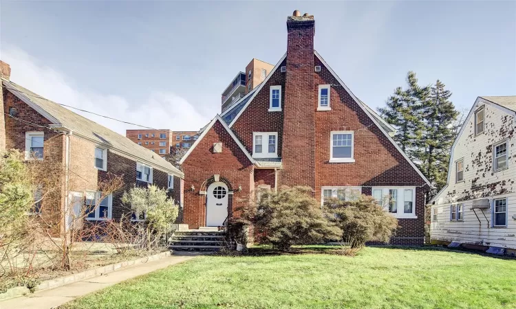 Tudor home featuring a front yard