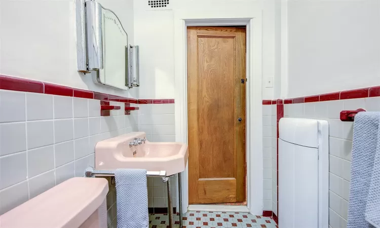 Bathroom with tile walls and toilet