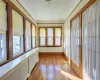 Unfurnished sunroom featuring radiator heating unit