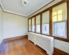 Unfurnished room featuring crown molding, dark hardwood / wood-style flooring, radiator heating unit, and a textured ceiling