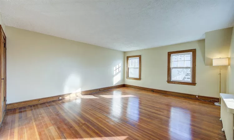 Spare room featuring hardwood / wood-style floors and a textured ceiling