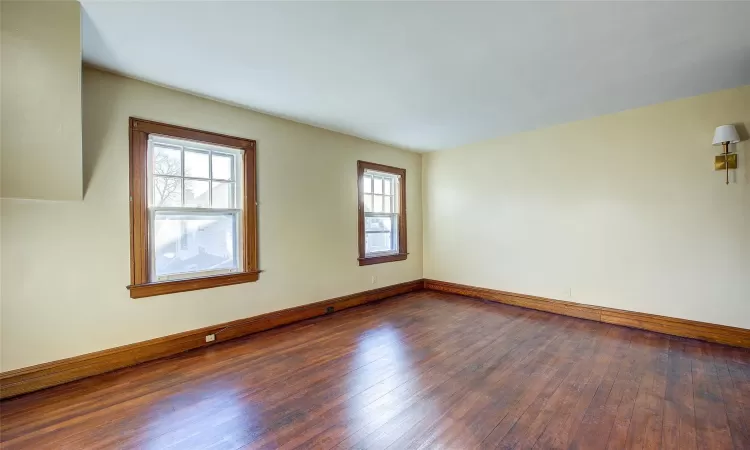 Unfurnished room featuring dark hardwood / wood-style flooring