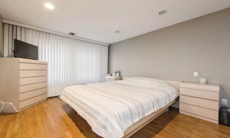 1st Fl - Bedroom featuring wood-type flooring