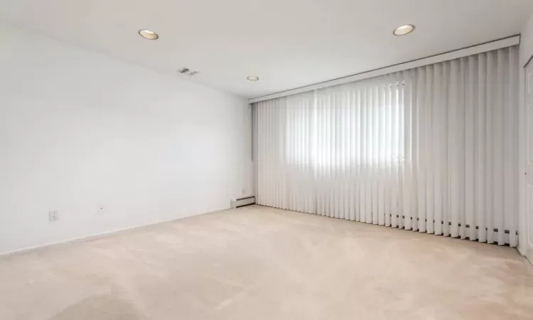 2nd Fl - Carpeted Bedroom featuring baseboard heat