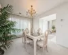 Dining room with light colored carpet and an inviting chandelier