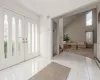 Foyer with high vaulted ceiling and light tile floors