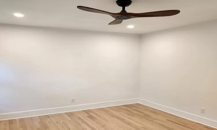 Unfurnished room with wood-type flooring and ceiling fan