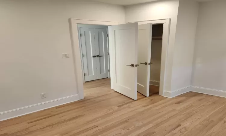 Unfurnished bedroom with light hardwood / wood-style flooring