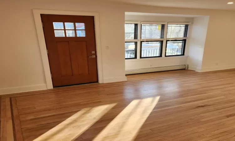 Entryway featuring baseboard heating and light hardwood / wood-style flooring