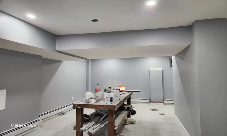 Office space featuring a baseboard radiator and concrete flooring