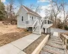 View of front of house featuring a deck and a sunroom