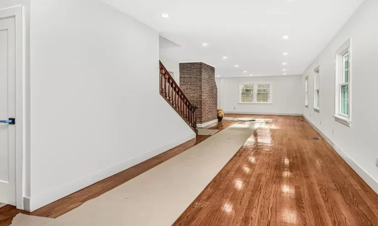 Hall with hardwood / wood-style flooring