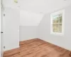 Bonus room featuring vaulted ceiling and hardwood / wood-style flooring