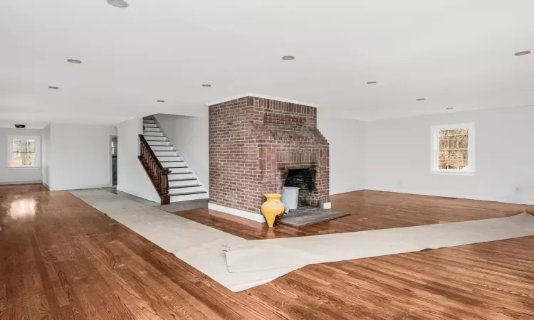 Unfurnished living room with a fireplace and light hardwood / wood-style flooring