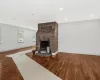 Living room featuring a brick fireplace and hardwood / wood-style flooring