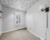 Carpeted empty room featuring a baseboard radiator