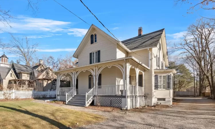 View of front of house featuring covered porch and a front yard