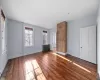 Unfurnished living room with dark hardwood / wood-style floors and radiator