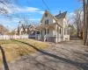 View of front of house featuring a front lawn and a porch