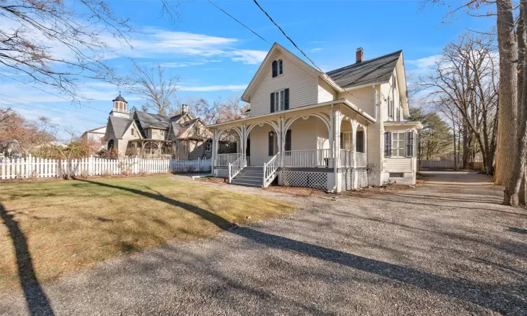 View of front of house featuring a front lawn and a porch