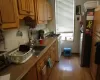 Kitchen with sink, light hardwood / wood-style flooring, white range with gas cooktop, and stainless steel refrigerator