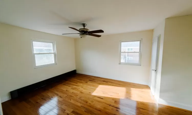 Empty room featuring light wood-type flooring and ceiling fan