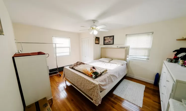 Bedroom featuring ceiling fan and dark hardwood / wood-style flooring