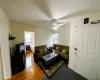 Living room with ceiling fan and hardwood / wood-style flooring