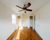 Unfurnished bedroom featuring ceiling fan and hardwood / wood-style floors