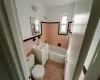 Full bathroom with toilet, vanity, tile walls, and tiled shower / bath combo