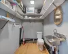 Bathroom featuring toilet, hardwood / wood-style flooring, and sink