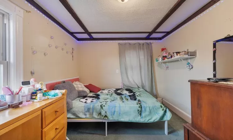 Bedroom with carpet floors and a textured ceiling