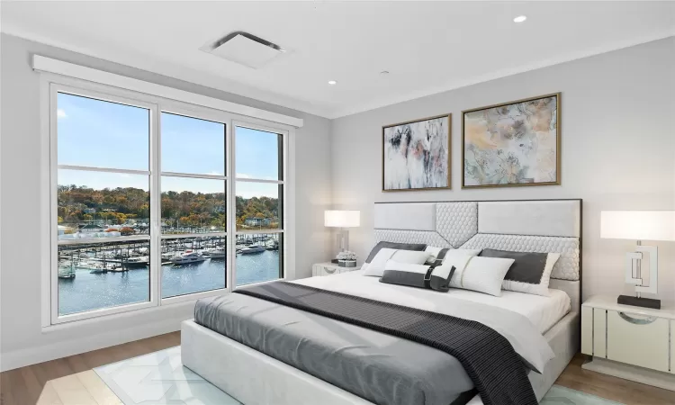 Bedroom with light wood-type flooring, a water view, multiple windows, and crown molding