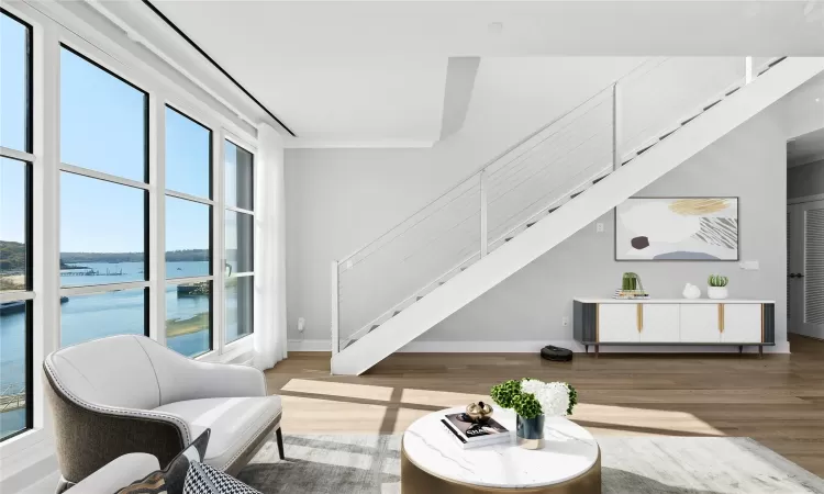 Living room featuring light hardwood / wood-style flooring and a water view