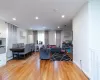 Living room with baseboard heating and wood-type flooring