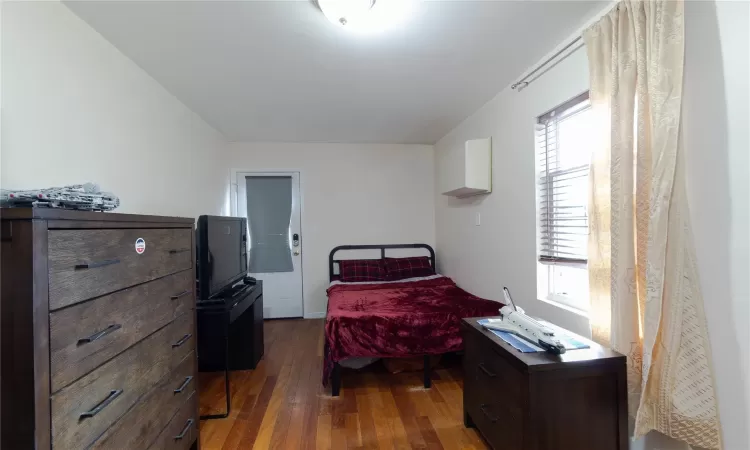 Bedroom featuring dark hardwood / wood-style flooring