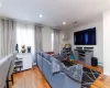 Living room with wood-type flooring and a baseboard radiator