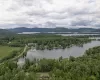 Birds eye view of property featuring a water and mountain view