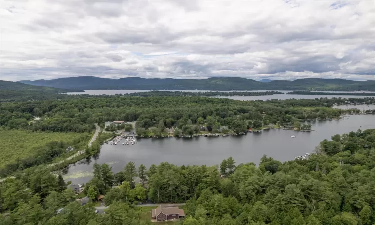 Birds eye view of property featuring a water and mountain view