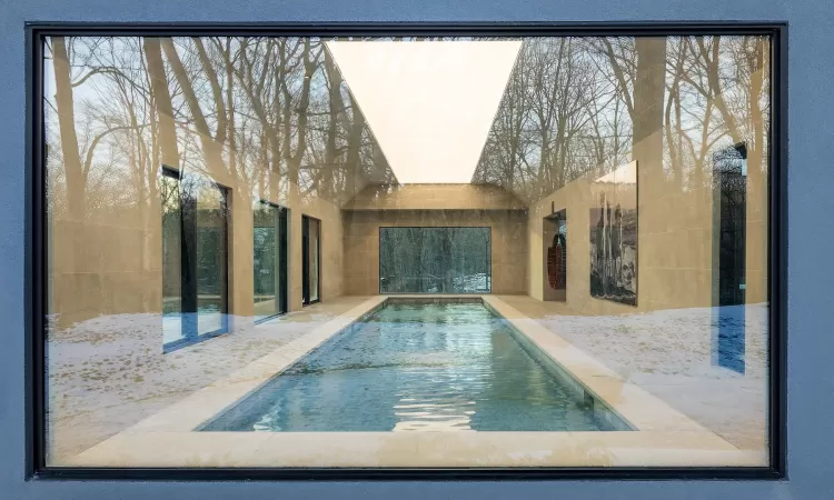 View of swimming pool from the  outside lookin into the Pool House