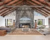 Italian tiled radiant floor, marble slab fireplace, high vaulted ceiling, wooden ceiling, and beamed ceiling