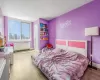 Bedroom with hardwood / wood-style flooring, a closet, and radiator heating unit